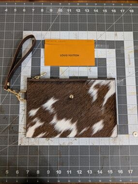 Upcycled large Wristlet W Strap Made W Hair On Cowhide & Authentic LV Hardware.